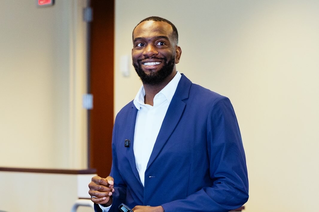 Fred smiling while speaking to an audience