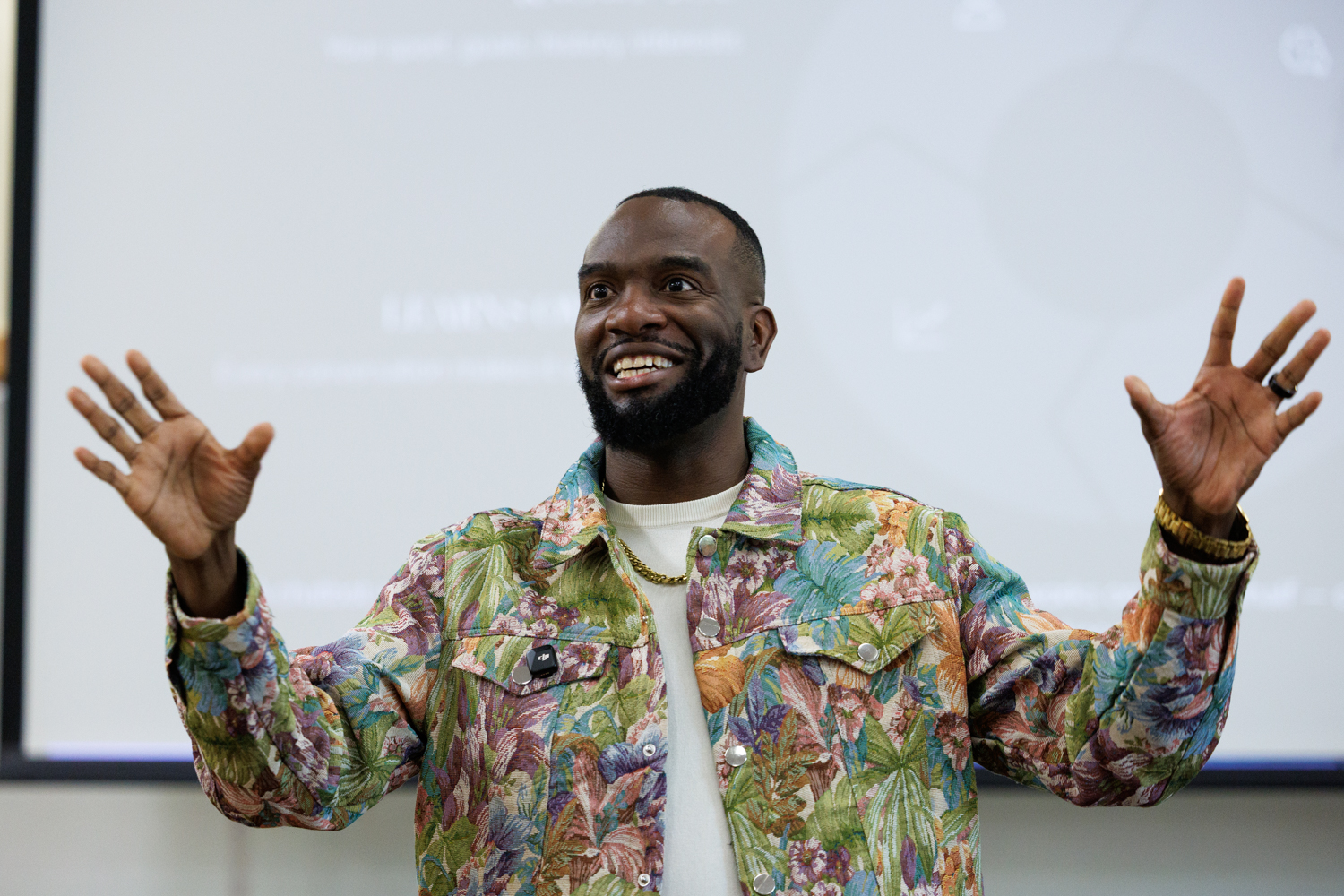 Fred presenting with his hands raised